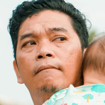 A close-up of a father holding a baby, Indonesia. Credit: Rendi iD/Pexels.