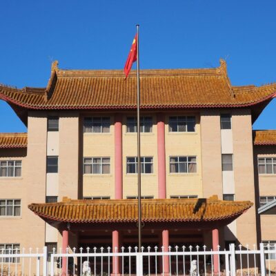 The main entrance to China’s embassy in Australia’s capital Canberra. A traditional Chinese style building with a Chinese flag.