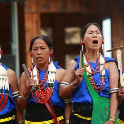 A group of 4 women standing in a row in traditional dress in Nagaland.