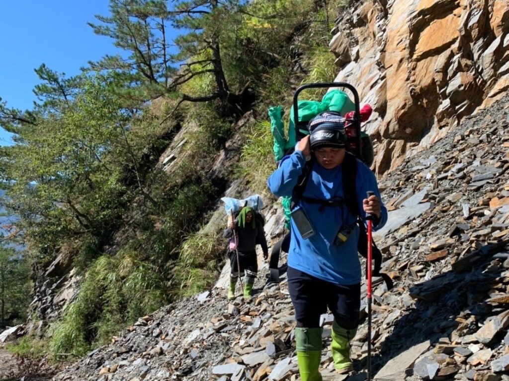 Tulbus Mangququ leading a pilgrimage to the ancestral homeland on the western side of the Central Mountain Range.