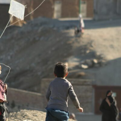 Two children in Afghanistan playing with a kite.